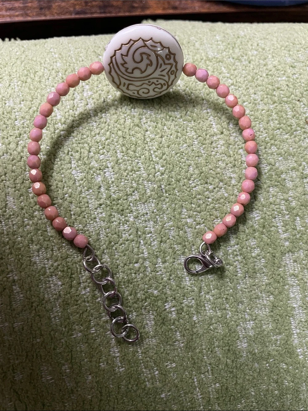 Clay Colored Beaded Bracelet with Off- White Gold-Trimmed Plastic Medallion
